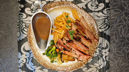 Smoked Brisket with Barbecue Sauce and Vegetables on a Decorative Plate