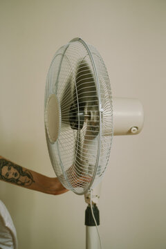 Unrecognizable person switching fan
