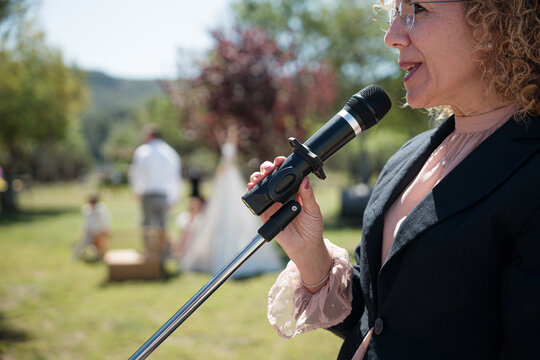 Woman speaking into microphone during wedding