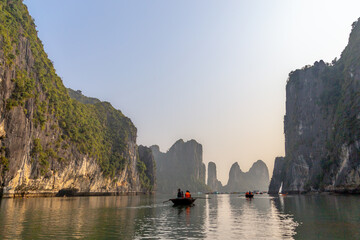 Beautiful view on tourist boats among limestone rocks of Ha Long Bay, Vietnam