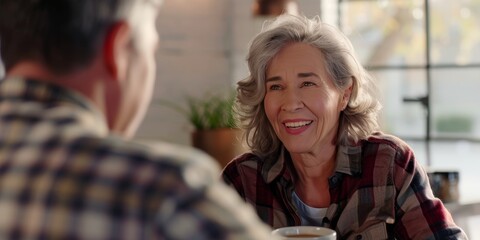 Obraz premium Toast to retirement and a senior couple sipping morning tea in their dining area. Smile, cheers, or chat with an older couple in their apartment for romance.
