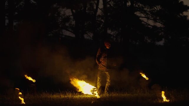 Brawny Handsome Man Dancing With Fire, Viking Or Old Slavic Pagan, Slow Motion In Darkness