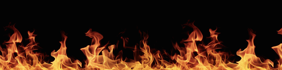Fototapeta premium A black background with a row of orange flames