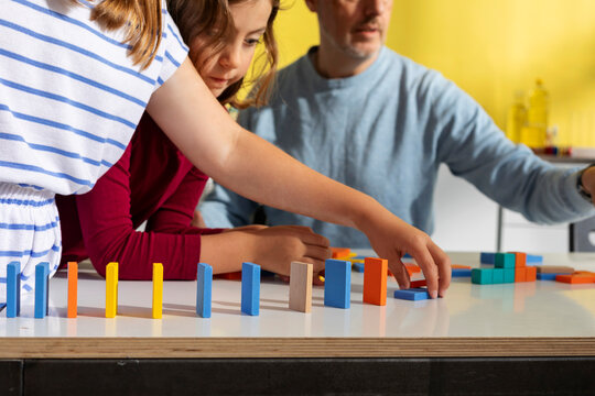 Kid Playing With Dominos