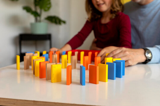 Kid Experimenting With Dominos