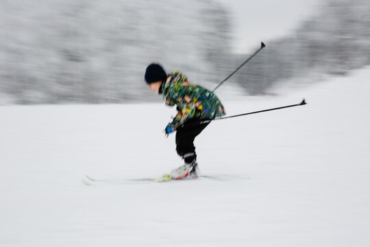 blurry photo of girl cross country skiing