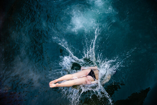 woman dives into icy water