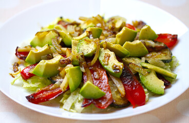 salad with vegetables, vegetarian avocado salad with grilled peppers, zucchini, parsley root and onions