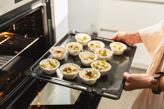 Mature Woman Baking Dessert in Modern Kitchen