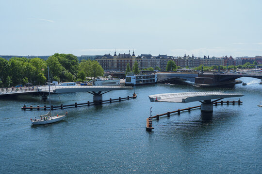 A pedestrian bridge raising its sections to allow boats to pass