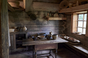 A cozy log cabin kitchen with a table and chairs for dining