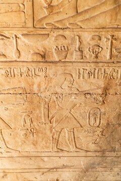 Ancient Egyptian hieroglyphics on stone wall, cultural heritage