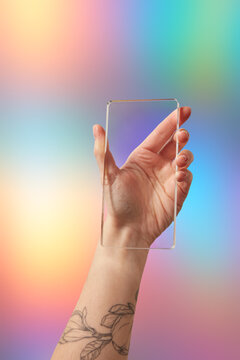 Cropped female holding glass imitating vertical portable computer