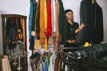 woman browsing vintage clothing in store