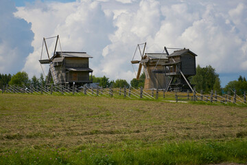 Fototapeta premium Three mills in a field