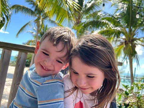 Cute happy siblings together on family tropical vacation