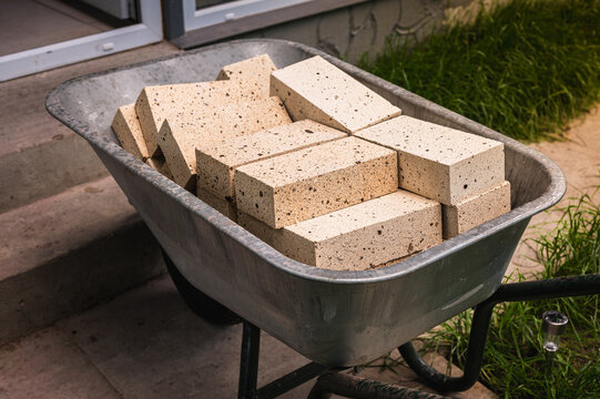 construction works, fireclay bricks are placed on a construction wheelbarrow