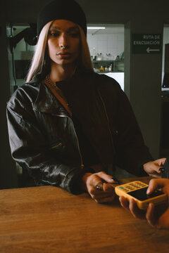 woman paying with card at bar