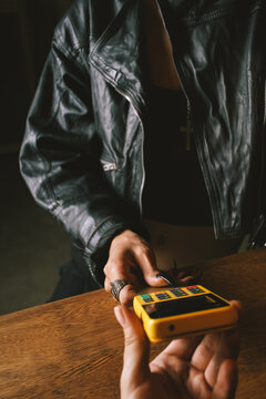 woman paying with card at bar
