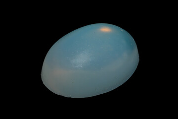 natural rainbow opal gem isolated on black background