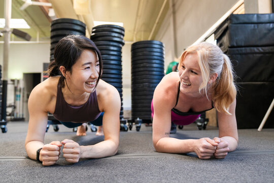 Two women workout inside gym - Powered by Adobe