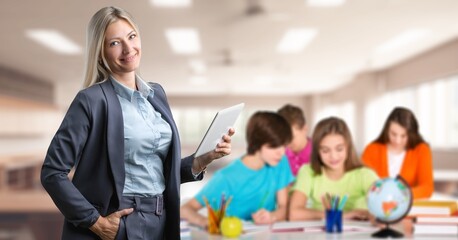 Portrait of cheerful female teacher in classroom