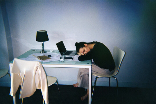Tired Woman Falling Asleep at Her Desk in Home Office 