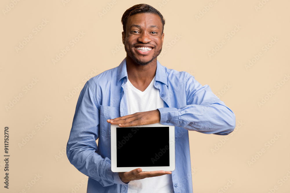 Canvas Prints Positive Afro Man Showing Blank Digital Tablet Screen Standing On Yellow Studio Background. Mockup