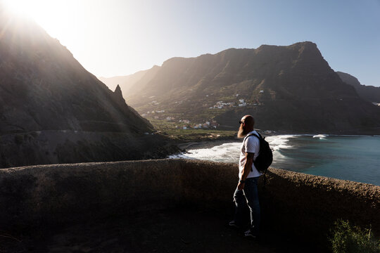 man exploring the mountains of la gomera with views of the sea