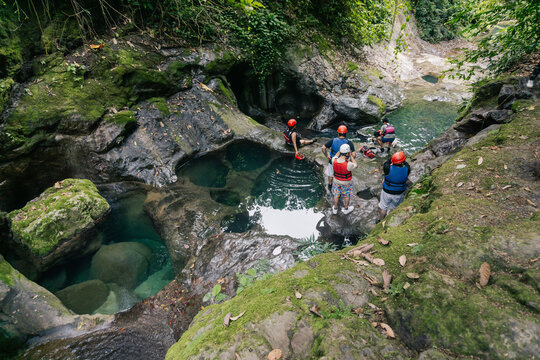 Unrecognizable group of tourists at a waterfall.