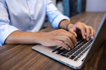 Businessman working online on laptop while sitting at workplace