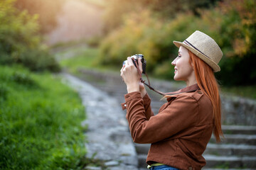 Female Tourist Capturing Outdoor Scenes with Camera