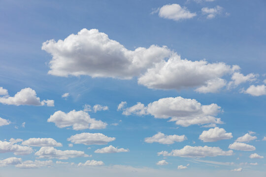 Cumulus clouds across vast blue sky