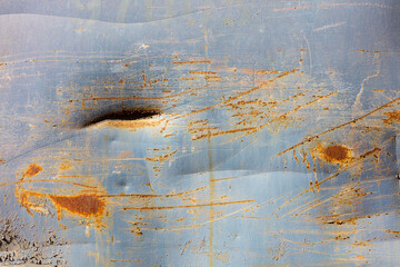 Peeling paint and rusty marks on metal