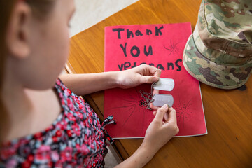 Military Dog tag veteran held by young girl 