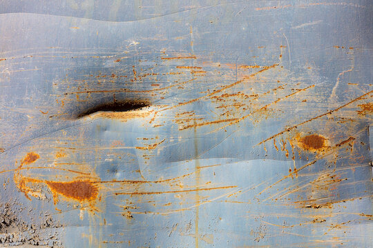 Peeling paint and rusty marks on metal