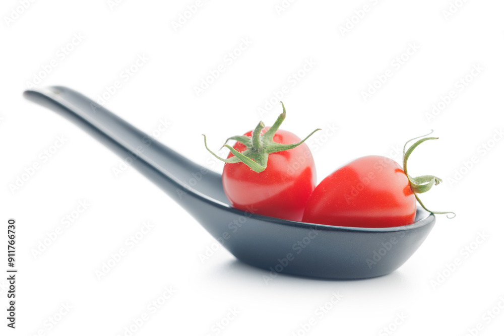 Sticker red cherry tomatoes in ceramic spoon isolated on white background.