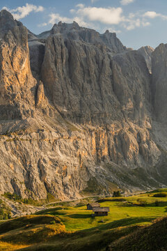 Scenic view of sunny meadow in Dolomites at sunset a