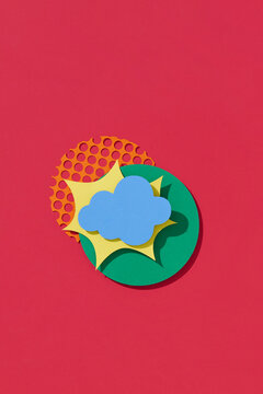 Colorful Paper Art of Cloud with Sun on Red Background