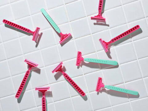 Colorful Razors on a White Tile Bathroom Surface