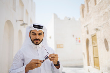 Man adjusting sunglasses