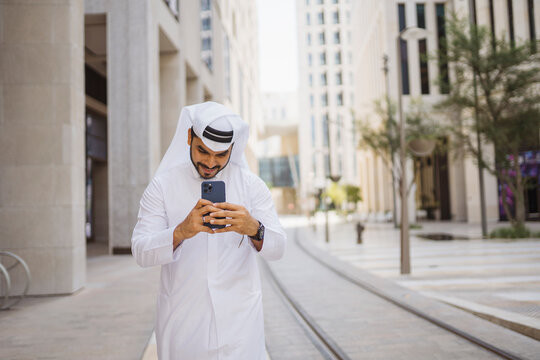 Man Checking Smartphone in City