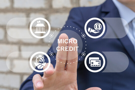 Man working on virtual touch screen presses text: MICROCREDIT. Micro credit Financing Business concept. Fast Micro Credit Loan Banking Technology. Micro Finance.