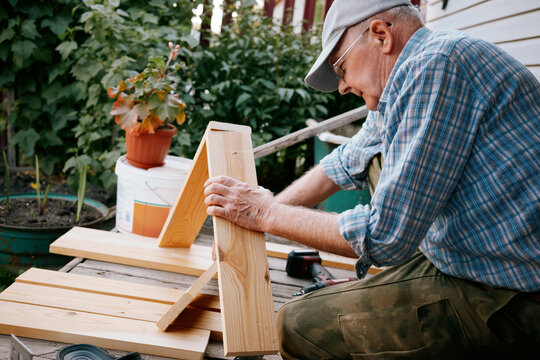 Senior Man Woodworking Outdoors
