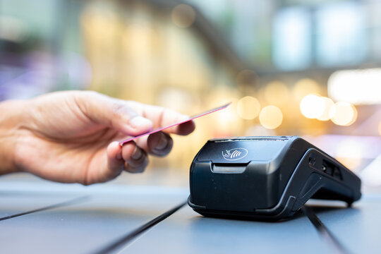 Man Using Credit Card at Checkout