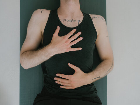 Closeup of Anonymous Young Man During Heart Meditation