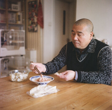 A man is making dumplings at home