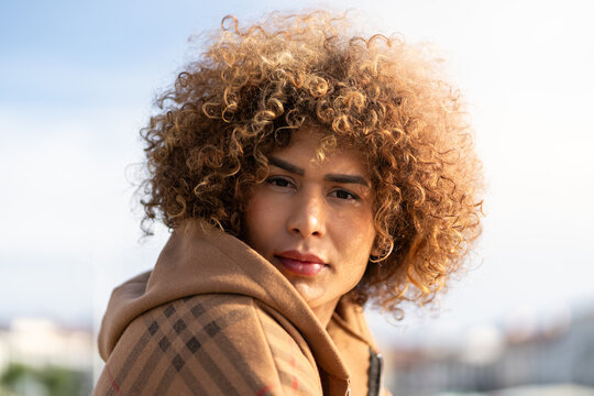 Portrait of a proud transgender woman with curly hair