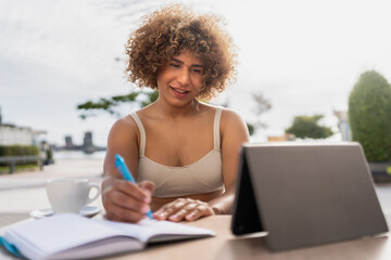 Inspired colombian woman journaling outdoors