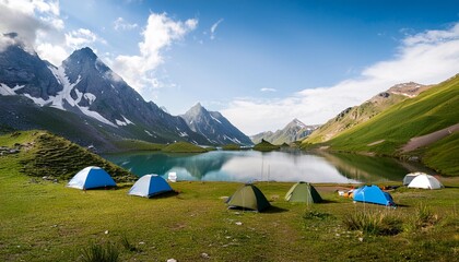 Camping on green land with lake and mountains